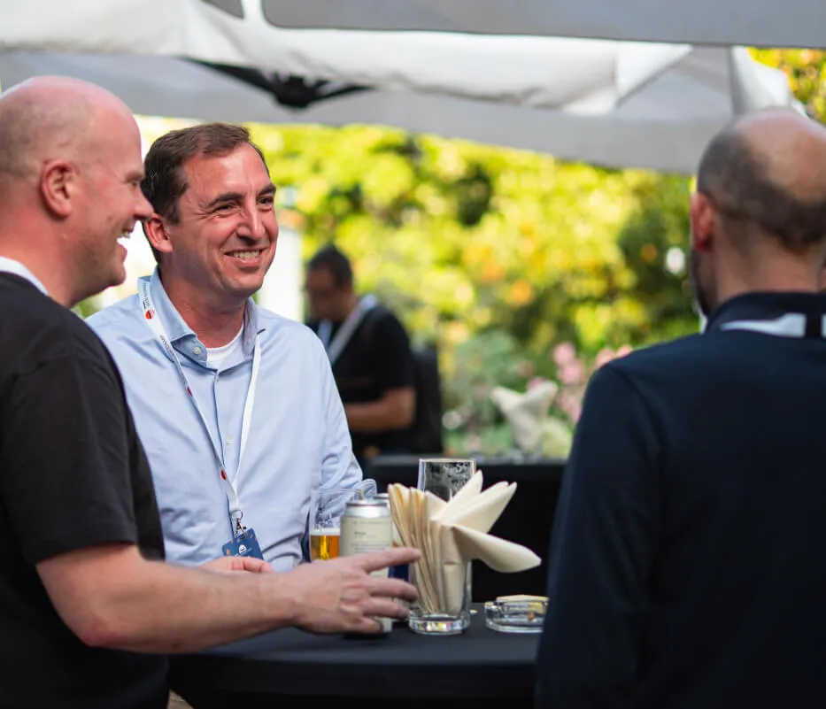 Peoples having good time on the conference. Three peoples having smiles at the table.